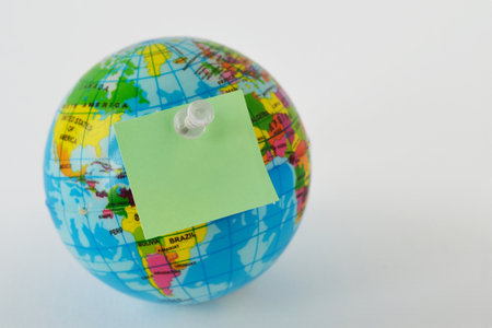 Planet earth with blank sticky note on white background - Concept of ecology and enivironmental conservationの写真素材