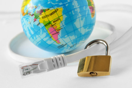 Internet cable with padlock and earth planet on white background - Concept of internet security and network protectionの写真素材