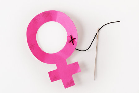 Female gender symbol sewn with neddle and thread - Concept of abuse and violence against womenの写真素材