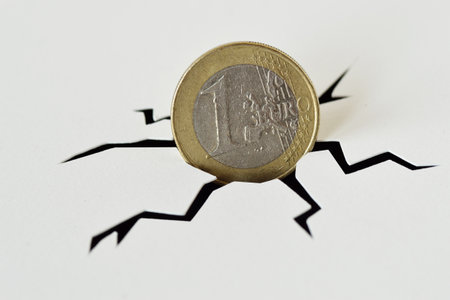 Euro coin in cracked ground - Crash of euro conceptの写真素材