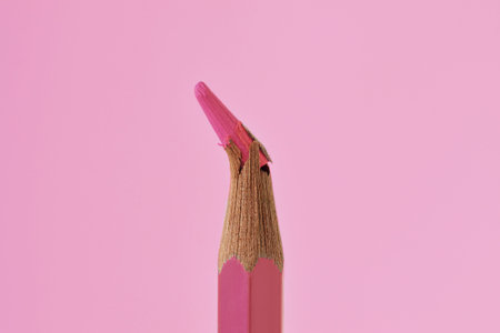 Close-up of broken tip of pink colored pencil on pink backgroundの写真素材