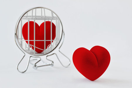 Heart looking in the mirror and seeing itself in a cage - Concept of love and freedomの写真素材