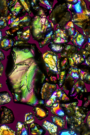 Large grain of sand left of smaller grains from a Connecticut beach on Long Island Sound. Light...