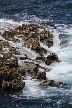Surf of the Bay of Naples in the Mediterranean Sea on rocks off the shore of Sorrento Campania Italy along the Amalfi Coast.の写真素材
