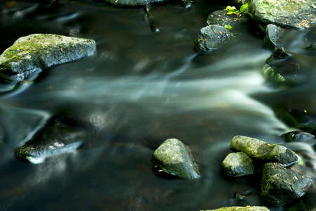 Long exposure creates light streaks in the rapids of the Blackledge River in Gay City State Park...