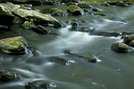 Long exposure creates light streaks in the rapids of the Blackledge River in Gay City State Park Hebron Connecticut.の写真素材