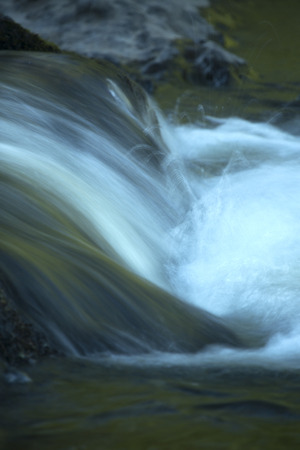 Vertical image of small waterfall in rapids of the Farmington River, Nepaug Forest, New Hartford, Connecticut.の写真素材