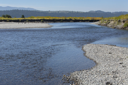 Bend in the Buffalo Fork River near Moran, in northern Jackson Hole, Wyoming, with gravel along the riverbank.の写真素材