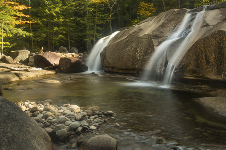 Waterfalls of Lucy Brook cascade over granite wall into plunge pool at Diana's Baths in Bartlett, New Hampshire.の写真素材