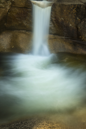 Silky long exposure of waterfall over granite ledge into plunge pool at Diana's Baths near North Conway, New Hampshire.の写真素材