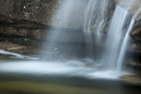 Long exposure of waterfall over granite ledge at Diana's Baths near North Conway, New Hampshire, close view.の写真素材