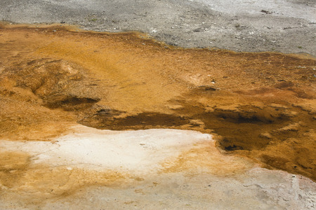 Colorful, orange geothermal riveulets over the travertine rock of Mammoth Hot Springs in Yellowstone National Park, Wyoming.の写真素材