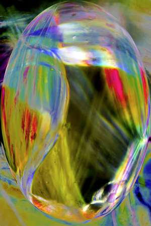 Bright, vibrant, abstract micrograph of multicolor spider silk glowing at 100x, digitally altered with polarization.の写真素材