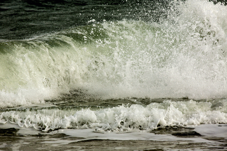 Big waves from the open Atlantic Ocean roll in and crash on the beach of Assateague Island National Seashore in Maryland, USA.の写真素材