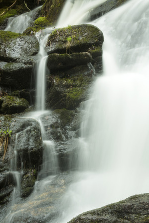 Silky flowing water in a section of Carpenter's Falls on Beach Brook in early spring at McLean Game Refuge in Granby, Connecticut.の写真素材