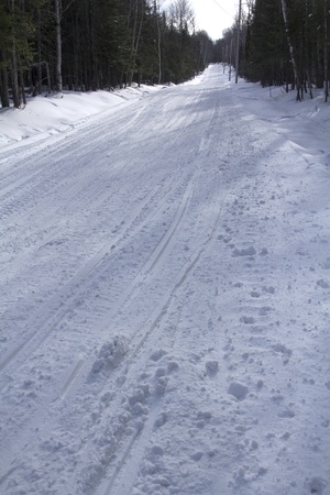 Snowmobile and hiking trail covered in snow in winter on Bald Mountain in Rangeley, Maine.の写真素材