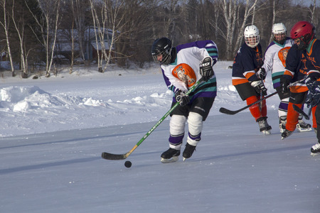 Women's teams compete on the ice at the 11th annual New England Pond Hockey Festival on Haley Pond...