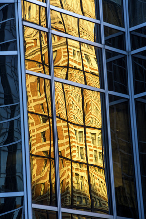 Abstract reflections in mirror-like glass of a building in PPG Place, at the end of a sunny fall day in downtown Pittsburgh, Pennsylvania.の写真素材