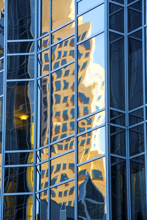 Abstract reflections in mirror-like glass of a building in PPG Place, at the end of a sunny fall day in downtown Pittsburgh, Pennsylvania.の写真素材