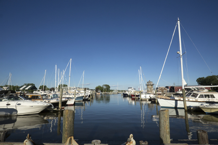 ESSEX, CONNECTICUT, USA - June 19, 2018: Boats float in a marina at Essex on the Connecticut River.のeditorial素材