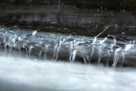 Bubbles and patterns inside clear icicles at Blackledge Falls Park in Glastonbury, Connecticut.の写真素材