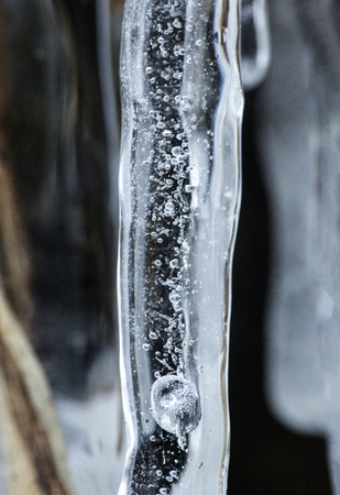 Bubbles and patterns inside clear icicles at Blackledge Falls Park in Glastonbury, Connecticut.