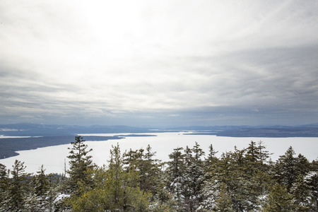 View of a frozen Mooselookmeguntic Lake from the summit of Bald Mountain in the woods of northern Maine.の写真素材