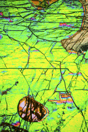 Abstract micrograph of the mineral olivine pyroxenite, viewed with a polarizing microscope at 100x.の写真素材