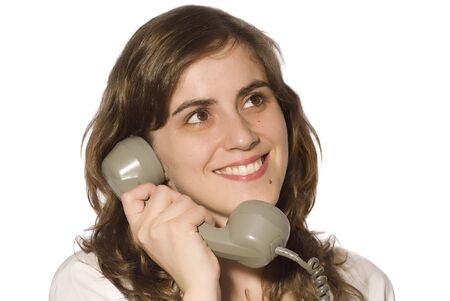young girl talking on the phone in white backgroundの写真素材