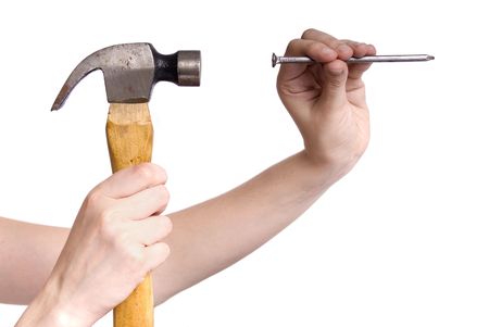 hand holding a hammer and fixing a nail in a white backgroundの写真素材