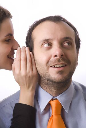 young woman whispering a secret to a business manの写真素材
