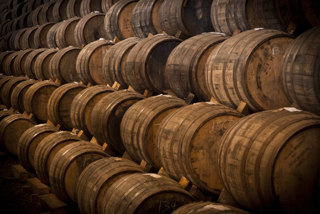Wine barrels stacked in the old cellar of the winery の写真素材