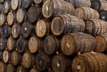 Wine barrels stacked in the old cellar of the wineryの写真素材