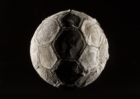 Old and vinatage soccer ball dark on black background.の写真素材