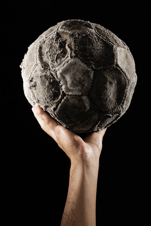 man hand with Old and vinatage soccer ball on white background.の写真素材