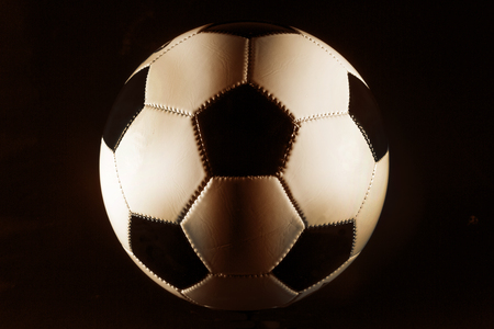 Black and white soccer ball on black background.の写真素材
