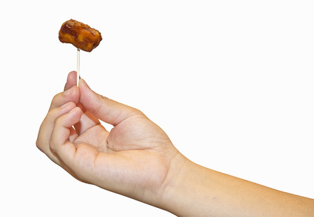 Hand Holding Meatball on Toothpick on White background.の写真素材