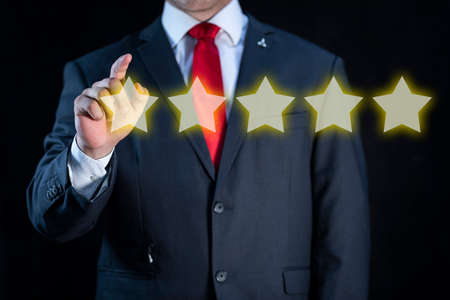 Elegant businessman rating a virtual service with five stars.