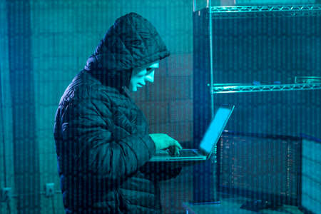 Hacker using laptop with binary code digital interface. Double exposure. Hacking and malware...