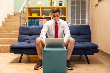 Young bussines man in COVID-19 disease quarantine. Man taking a job meeting onlineの写真素材