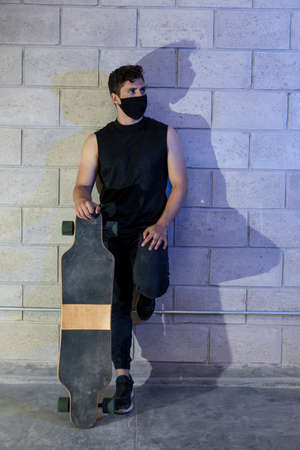 Young and attractive man after skating in a big cellarの写真素材