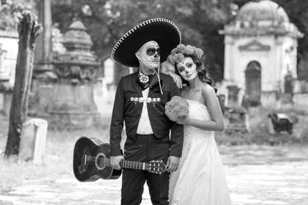 Catrin and Catrina in cemetery with wedding dresses in an old cemetery of Guadalajara, Mexico.の写真素材