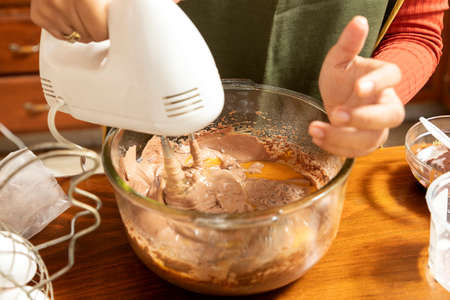 Detail of blender mixing ingredients to make homemade cakes. Egg, flour, butter, milk, sugar.の写真素材