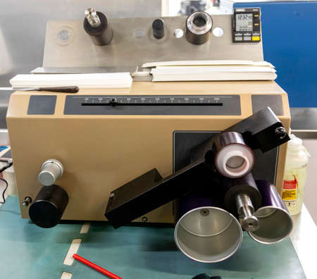 Close up of an offset printing machine during production. Comparing pantones