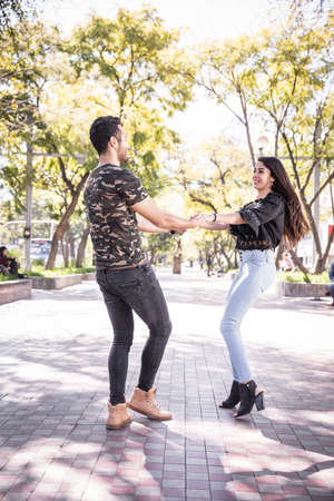 happy young couple in love expressing mutual love in the outdoors. mexican coupleの写真素材