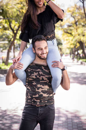 happy young couple in love expressing mutual love in the outdoors. mexican couple
