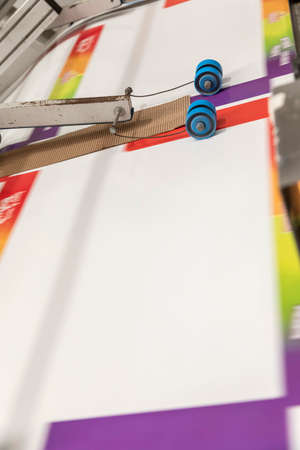 Close up of an offset printing machine during production