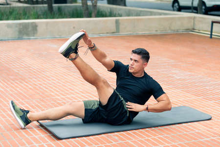 Young man exercising outdoors. Sports lifestyle.