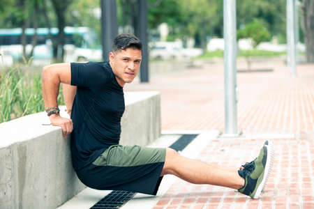 Young man exercising outdoors. Sports lifestyle.
