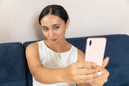 Young people addicted watching the tv and using cellphones at home